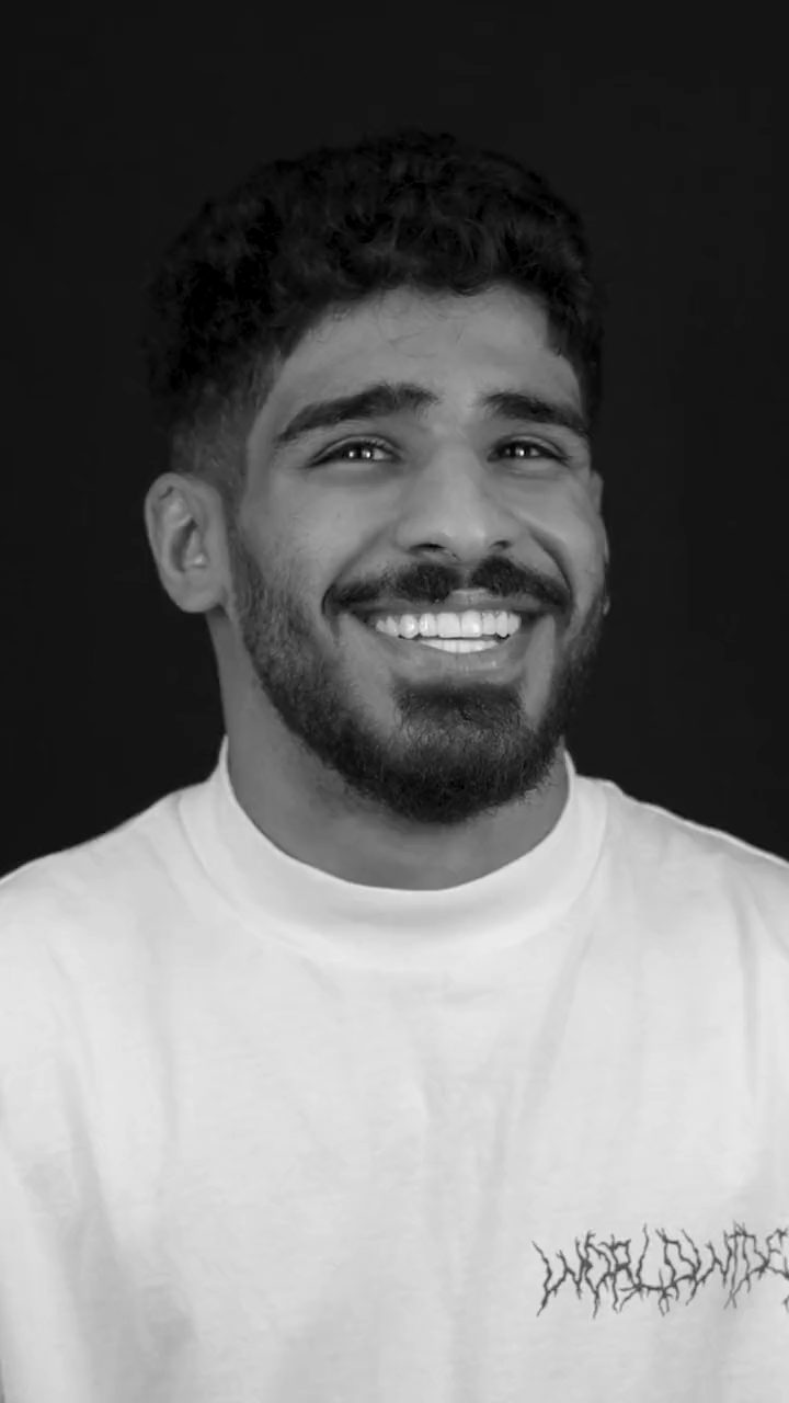 Black-and-white portrait of a smiling man, filmed at Creative Arts Dubai