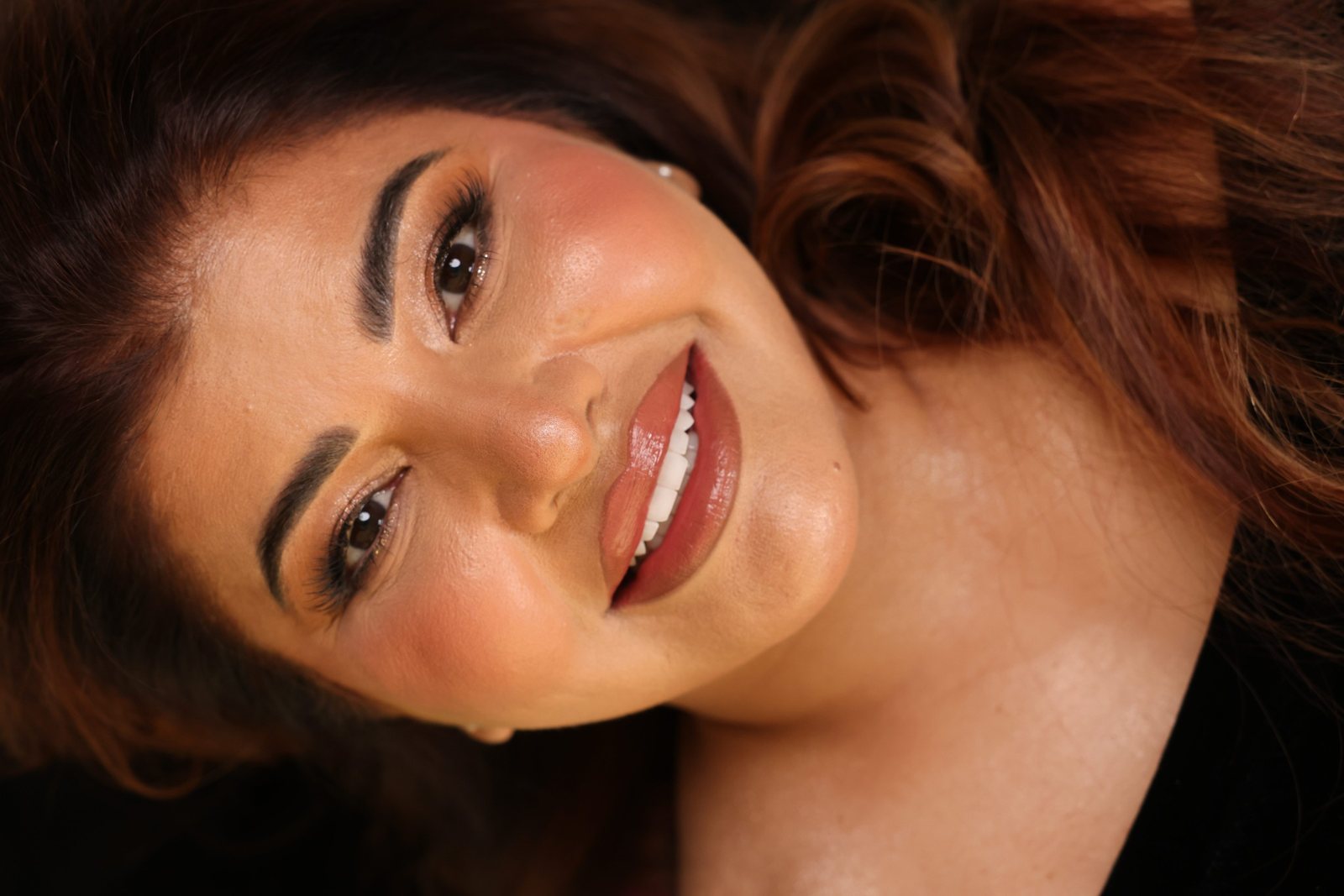 Woman's new smile after a smile makeover in Dubai: studio portrait and close-up of even, bright teeth